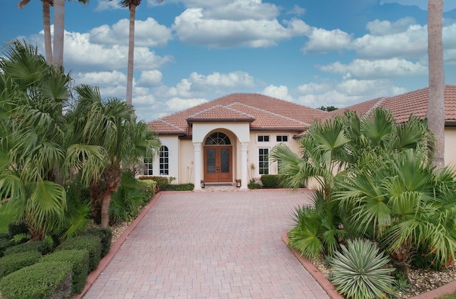 mediterranean / spanish house featuring french doors