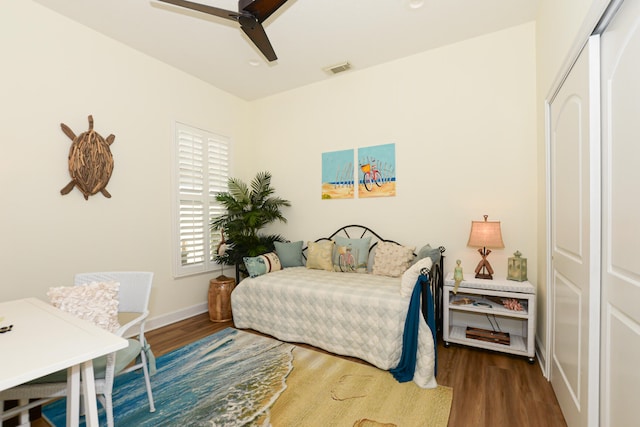 bedroom featuring hardwood / wood-style floors, a closet, and ceiling fan