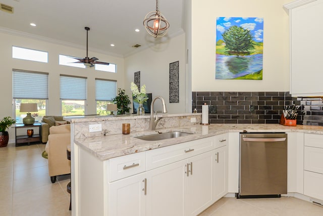 kitchen with light stone countertops, white cabinetry, stainless steel dishwasher, and sink