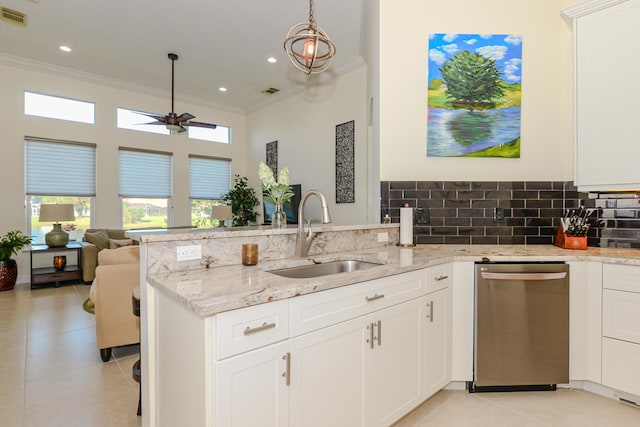 kitchen featuring sink, stainless steel dishwasher, white cabinets, and light stone counters