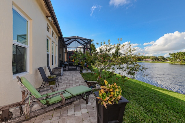 view of patio / terrace with a water view and glass enclosure