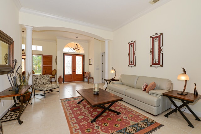 living room featuring decorative columns, crown molding, french doors, and light tile patterned floors