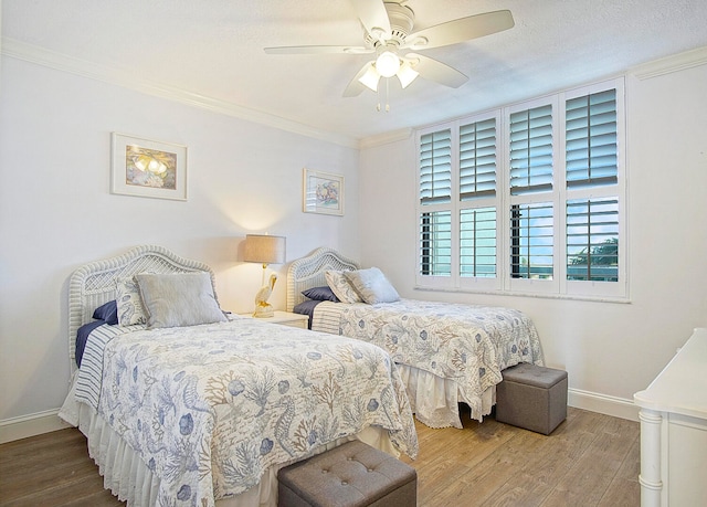 bedroom featuring a textured ceiling, wood-type flooring, ceiling fan, and crown molding