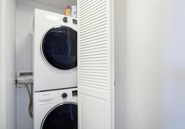 washroom featuring stacked washer / dryer