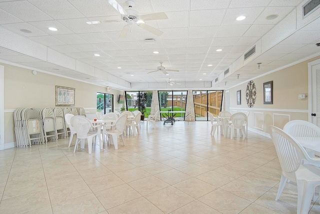 dining area with light tile patterned flooring, ceiling fan, and crown molding