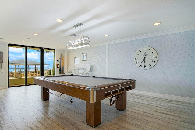 rec room featuring billiards, light hardwood / wood-style flooring, wood walls, and crown molding