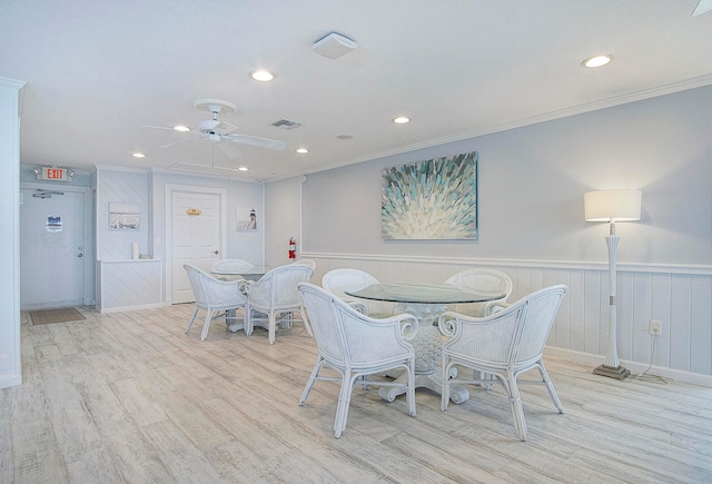 dining area featuring ornamental molding, ceiling fan, and light hardwood / wood-style flooring