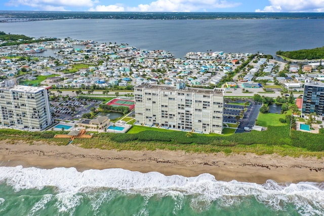 bird's eye view with a water view and a beach view