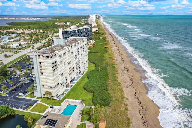 bird's eye view featuring a view of the beach and a water view