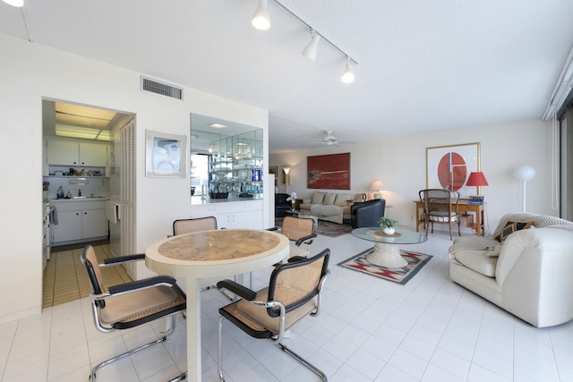 tiled living room featuring ceiling fan