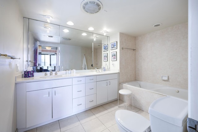 bathroom featuring toilet, vanity, and tile patterned floors