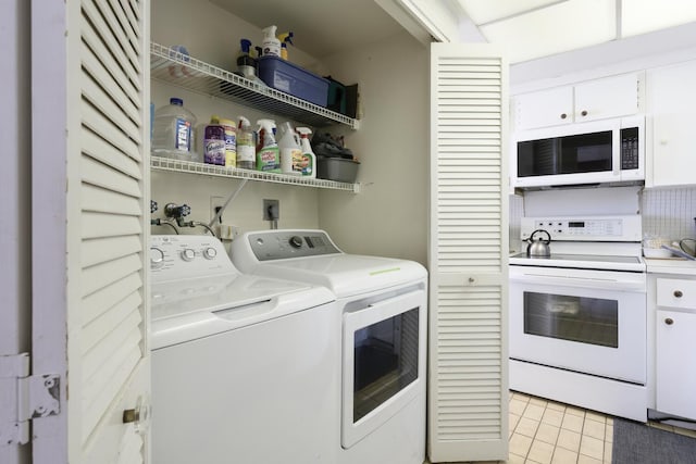 laundry room with washing machine and clothes dryer and light tile patterned floors