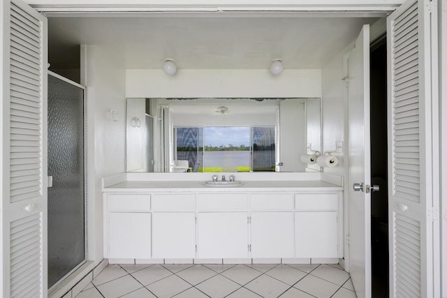 bathroom featuring an enclosed shower, vanity, and tile patterned floors