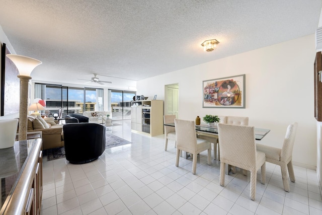 tiled dining room with floor to ceiling windows, a textured ceiling, and ceiling fan