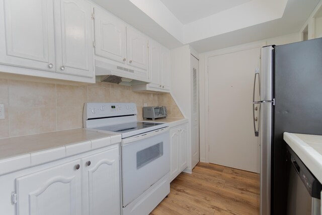 unfurnished room with a textured ceiling, hardwood / wood-style flooring, and baseboards