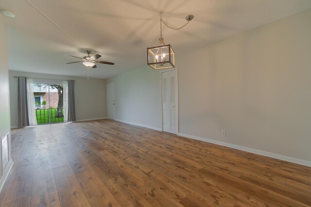 unfurnished bedroom with baseboards, a closet, visible vents, and wood finished floors