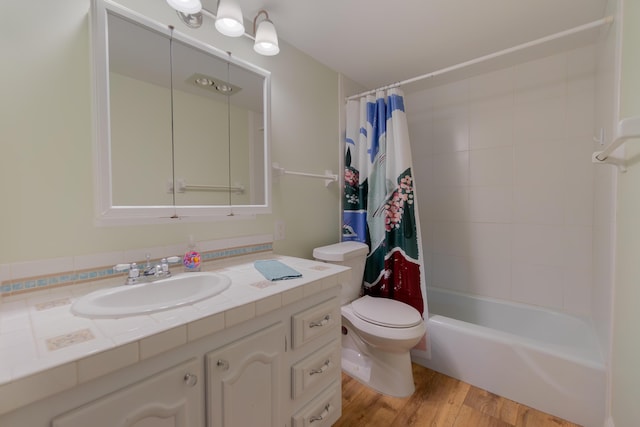 full bath featuring vanity, shower / tub combo, wood finished floors, and toilet