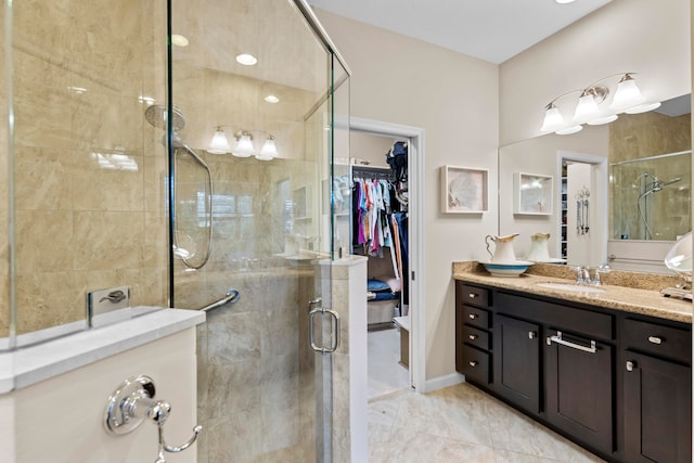 bathroom with a shower with door and vanity