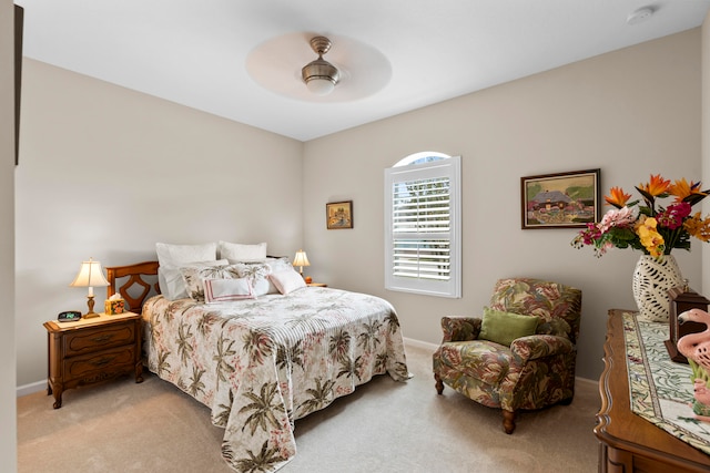 bedroom featuring ceiling fan and light carpet