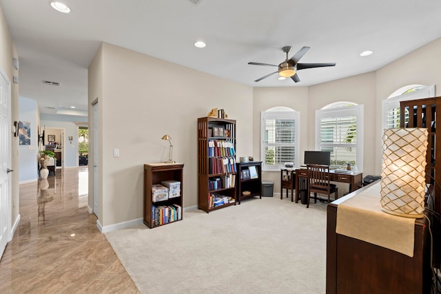 office space featuring ceiling fan and light colored carpet