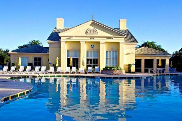 rear view of house featuring a community pool