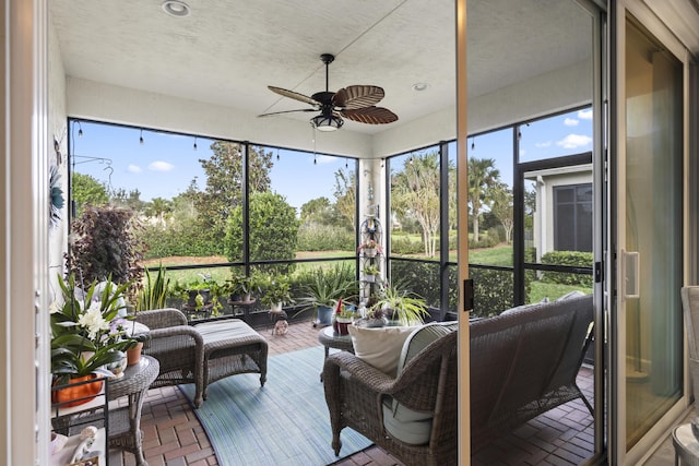 sunroom featuring ceiling fan