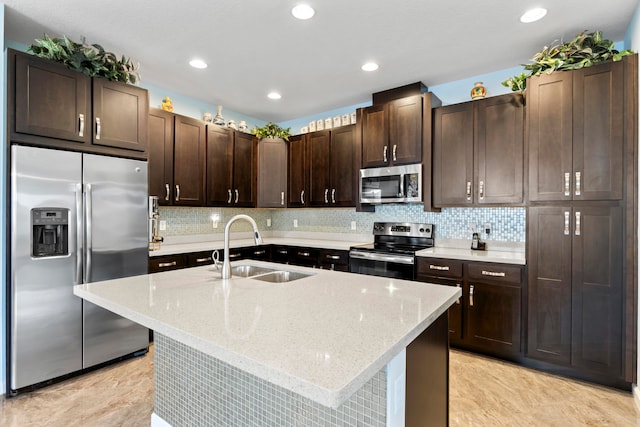 kitchen with light stone countertops, sink, stainless steel appliances, and dark brown cabinetry