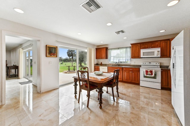 dining room featuring a wealth of natural light and sink