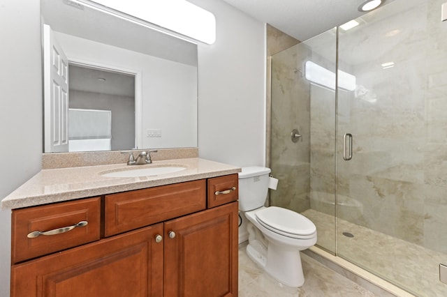 bathroom with vanity, an enclosed shower, and toilet