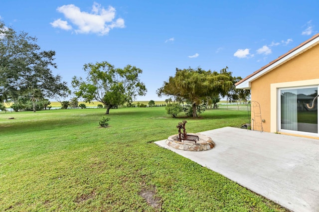 view of yard featuring a patio and an outdoor fire pit