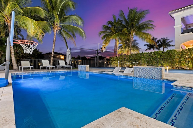 view of pool at dusk