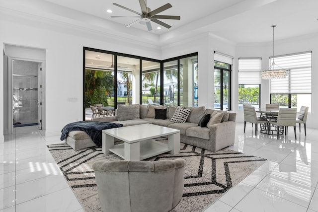 living room with ceiling fan and ornamental molding