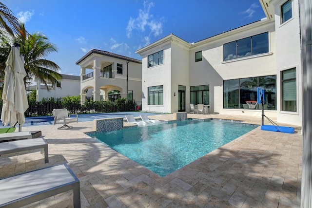 view of swimming pool with a hot tub and a patio area