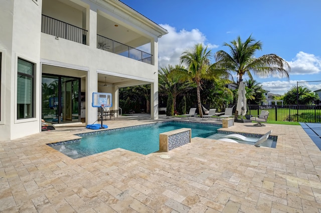 view of pool with a hot tub and a patio area