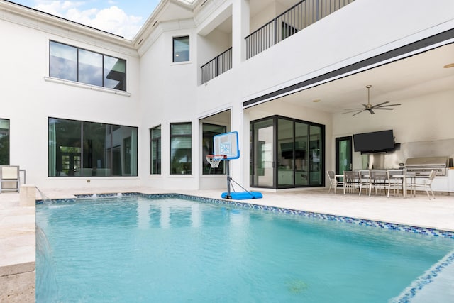 view of swimming pool featuring ceiling fan, a patio area, area for grilling, grilling area, and pool water feature