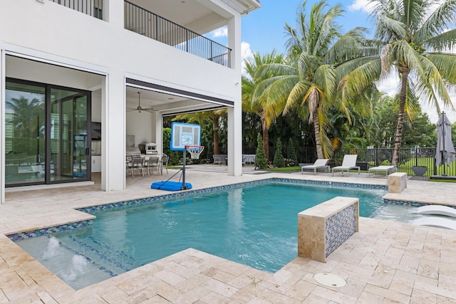 view of swimming pool featuring a patio area and ceiling fan