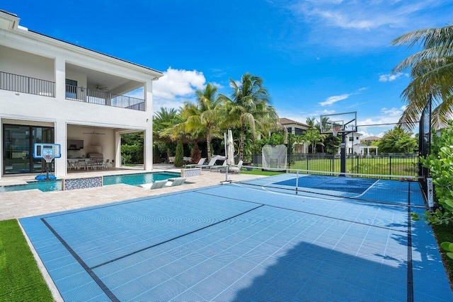 view of pool featuring a patio area, basketball hoop, and tennis court