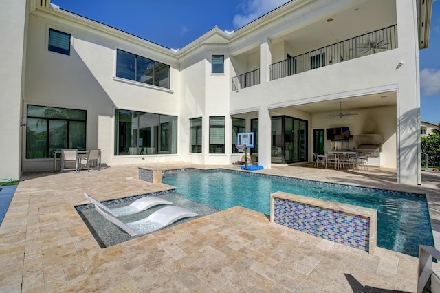 view of pool with a patio and ceiling fan