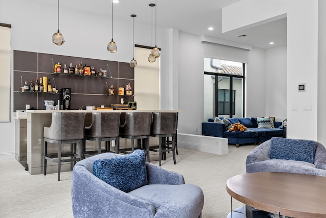 bar with decorative light fixtures and light colored carpet