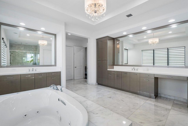 bathroom with a raised ceiling, a notable chandelier, vanity, and plus walk in shower