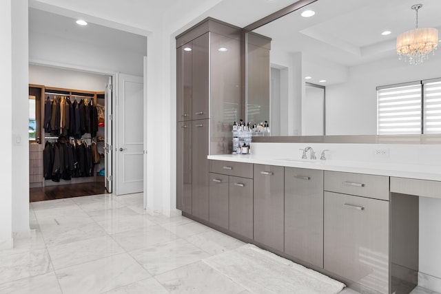 bathroom with vanity and a chandelier