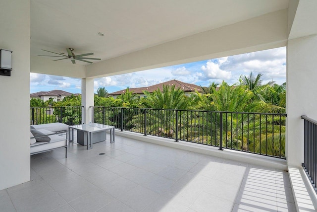 view of patio / terrace with ceiling fan and a balcony