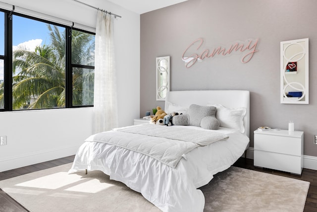 bedroom with dark hardwood / wood-style flooring