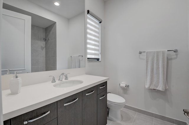 bathroom featuring tile patterned flooring, vanity, and toilet