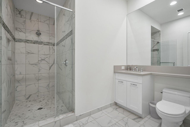 bathroom with vanity, toilet, and a shower with shower door