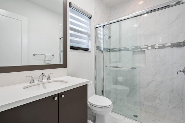 bathroom featuring vanity, an enclosed shower, and toilet