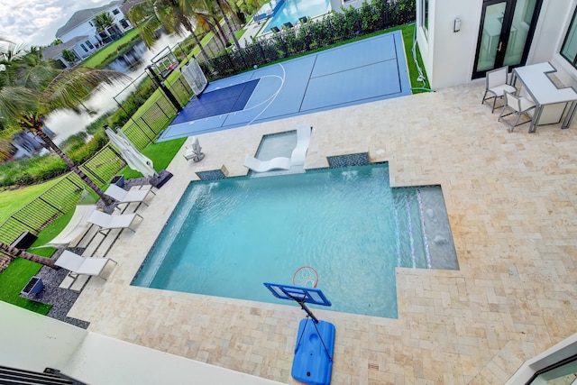 view of pool featuring pool water feature and basketball court