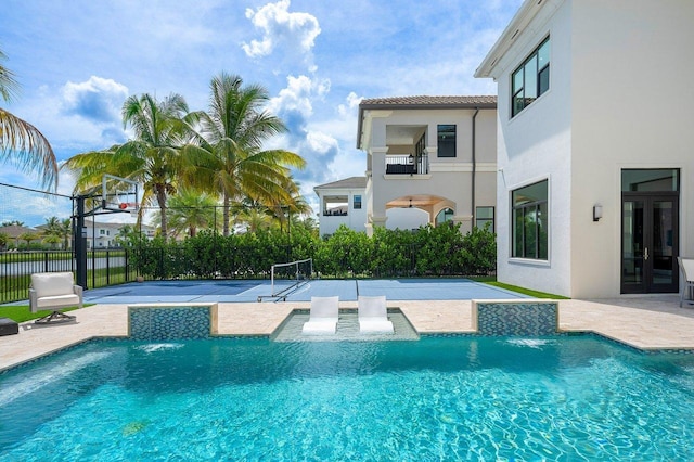 view of pool featuring pool water feature and basketball court