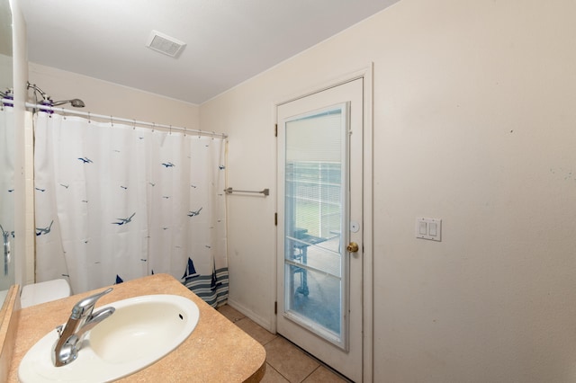 bathroom with tile patterned floors, sink, and walk in shower