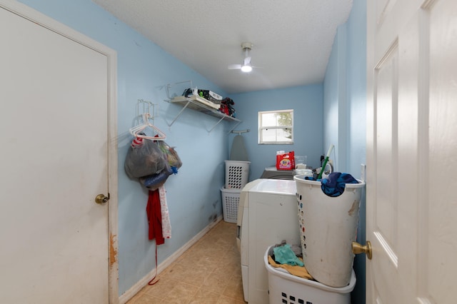 clothes washing area with separate washer and dryer and a textured ceiling